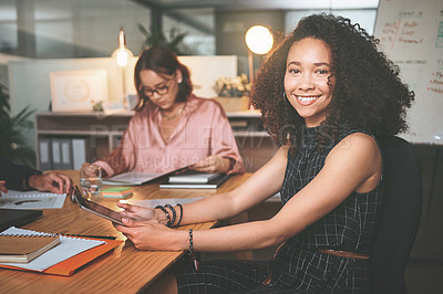 Buy stock photo Shot of an attractive young businesswoman sitting and using a digital tablet during a meeting in the office