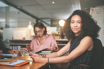 Buy stock photo Shot of an attractive young businesswoman sitting and using a digital tablet during a meeting in the office