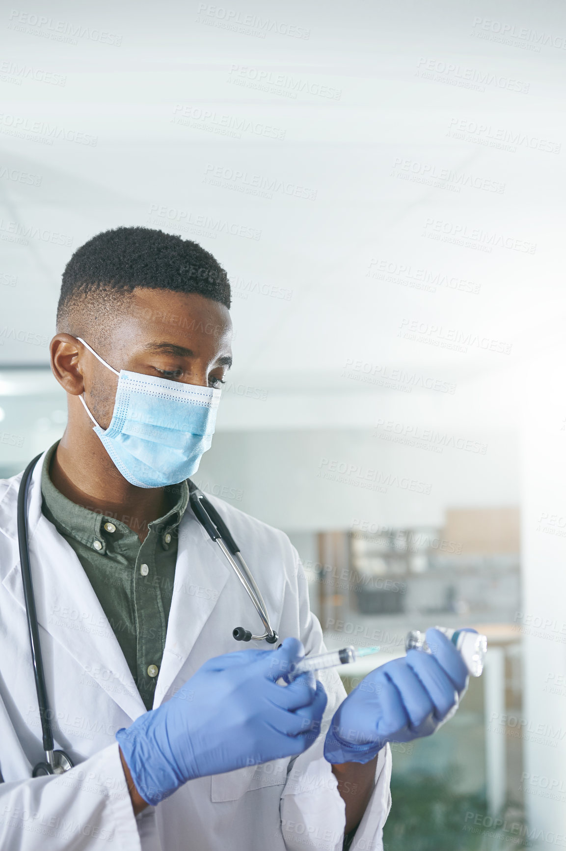 Buy stock photo Shot of a unrecognizable doctor holding a syringe in an office