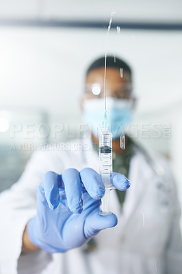 Buy stock photo Shot of a unrecognizable doctor holding a syringe in an office