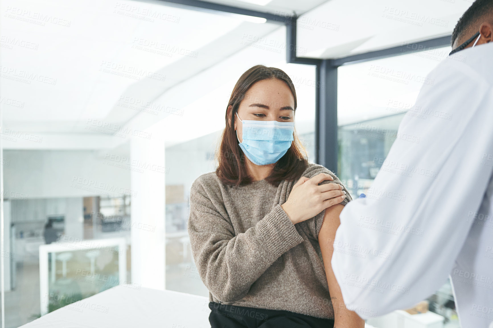 Buy stock photo Shot of an unrecognizable doctor giving a patient an injection in an office