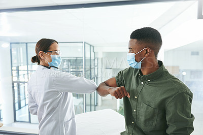 Buy stock photo Shot of a young doctor and patient greeting each other with an elbow bump in an office