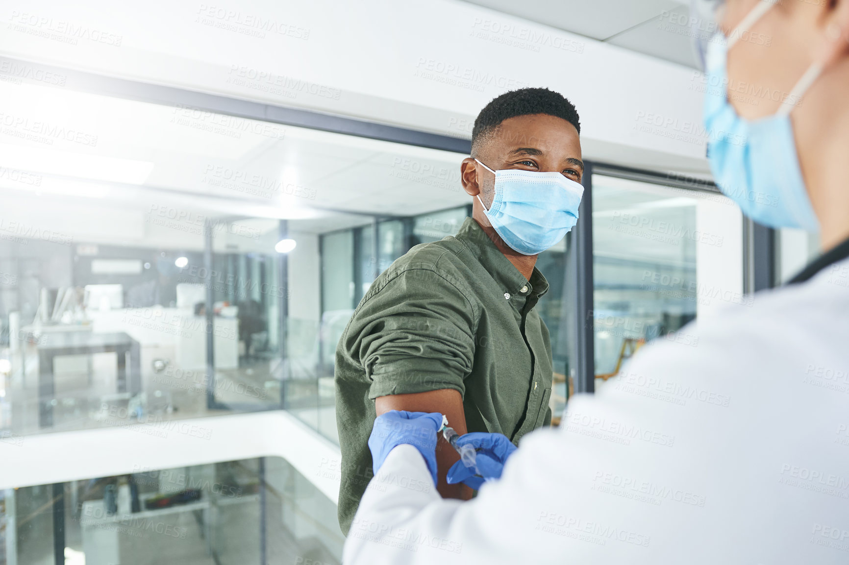 Buy stock photo Shot of an unrecognizable doctor giving a patient an injection in an office