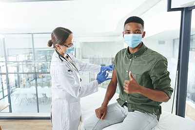 Buy stock photo Shot of a young doctor giving a patient an injection while he holds a thumbs up in an office