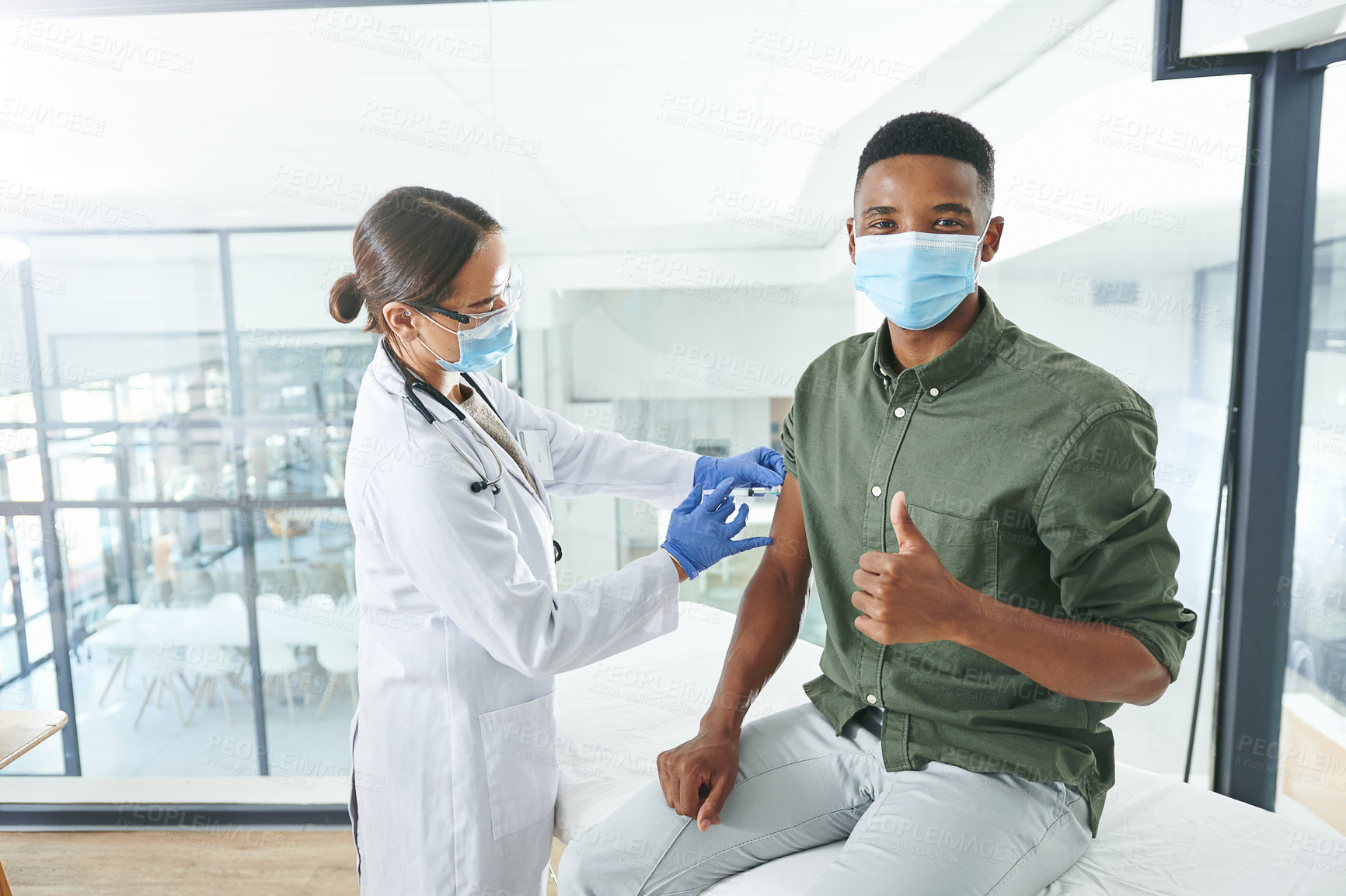 Buy stock photo Doctor, injection and man with thumbs up, portrait and healthcare policy for virus prevention. Medical service, patient and wellness in clinic, needle and gesture with safety, face mask and approval