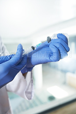 Buy stock photo Shot of a unrecognizable doctor holding a syringe in an office