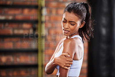 Buy stock photo Fitness, woman, and shoulder with injury from exercise on arm, muscle pain and inflammation with gym background. Female athlete, health and sport accident with painful joint and medical emergency