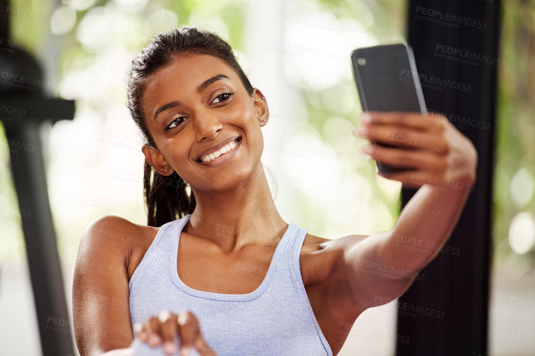 Buy stock photo Shot of a beautiful young woman taking a selfie while at the gym