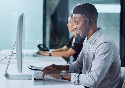 Buy stock photo Shot of a young call centre agent typing in an office