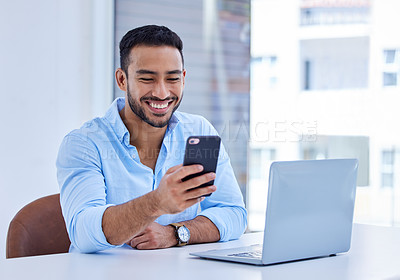 Buy stock photo Shot of a businessman using his smartphone to send a text at work