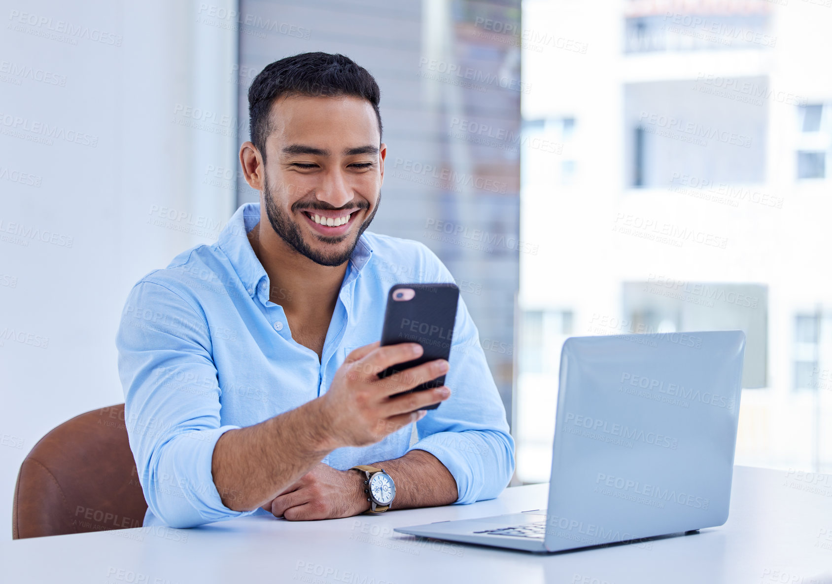 Buy stock photo Shot of a businessman using his smartphone to send a text at work