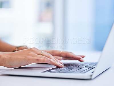 Buy stock photo Cropped shot of an unrecognizable businesswoman working on her laptop while sitting in the office