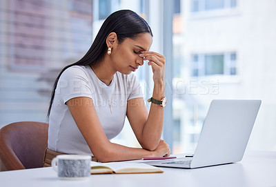 Buy stock photo Cropped shot of an attractive young businesswoman looking stressed while working on her laptop in the office