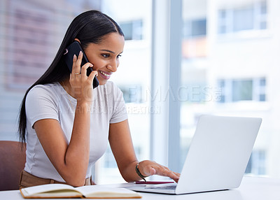 Buy stock photo Cropped shot of an attractive young businesswoman making a call while working on her laptop in the office