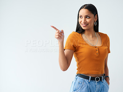 Buy stock photo Happy, pointing and hispanic woman in studio for news, deal or coming soon announcement with white background. Smile, mockup and female person with hand gesture for promotion, advertising or discount