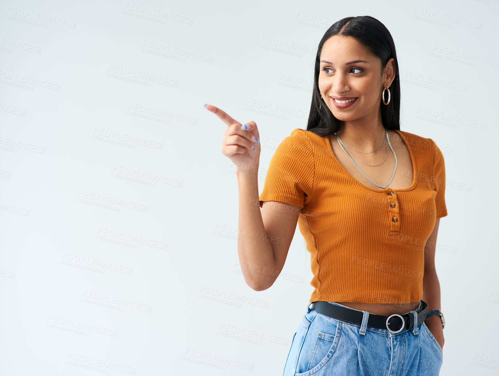Buy stock photo Happy, pointing and hispanic woman in studio for news, deal or coming soon announcement with white background. Smile, mockup and female person with hand gesture for promotion, advertising or discount