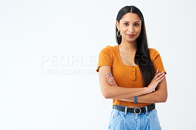 Buy stock photo Cropped shot of an attractive young woman standing with her arms folded in studio against a grey background