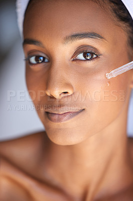 Buy stock photo Portrait, woman and serum for skincare, beauty or hyaluronic acid for wellness in home bathroom. Face, cosmetics and pipette for healthy collagen, essential oil or Indian girl with retinol to glow