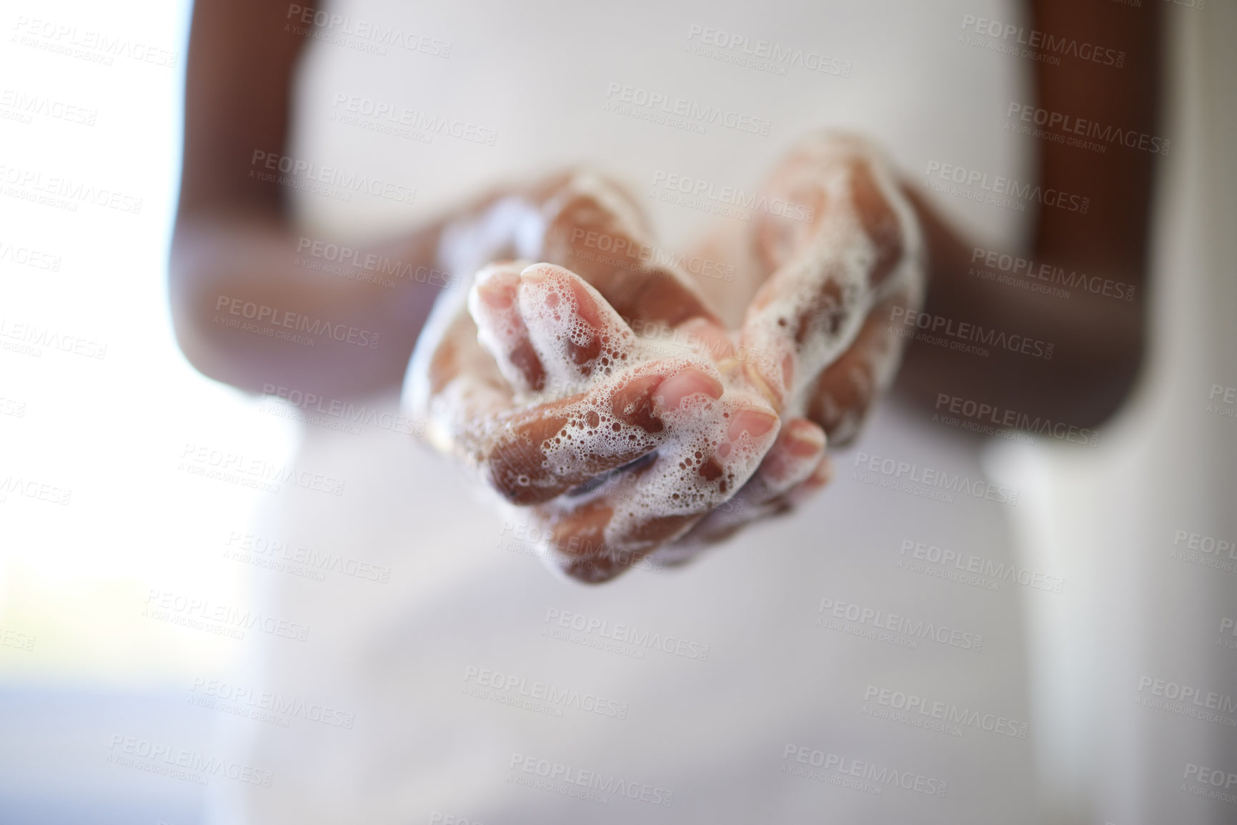Buy stock photo Closeup shot of an unrecognizable woman washing her hands in the bathroom at home