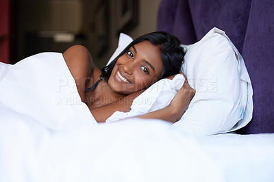 Buy stock photo Cropped portrait of an attractive young woman lying in bed