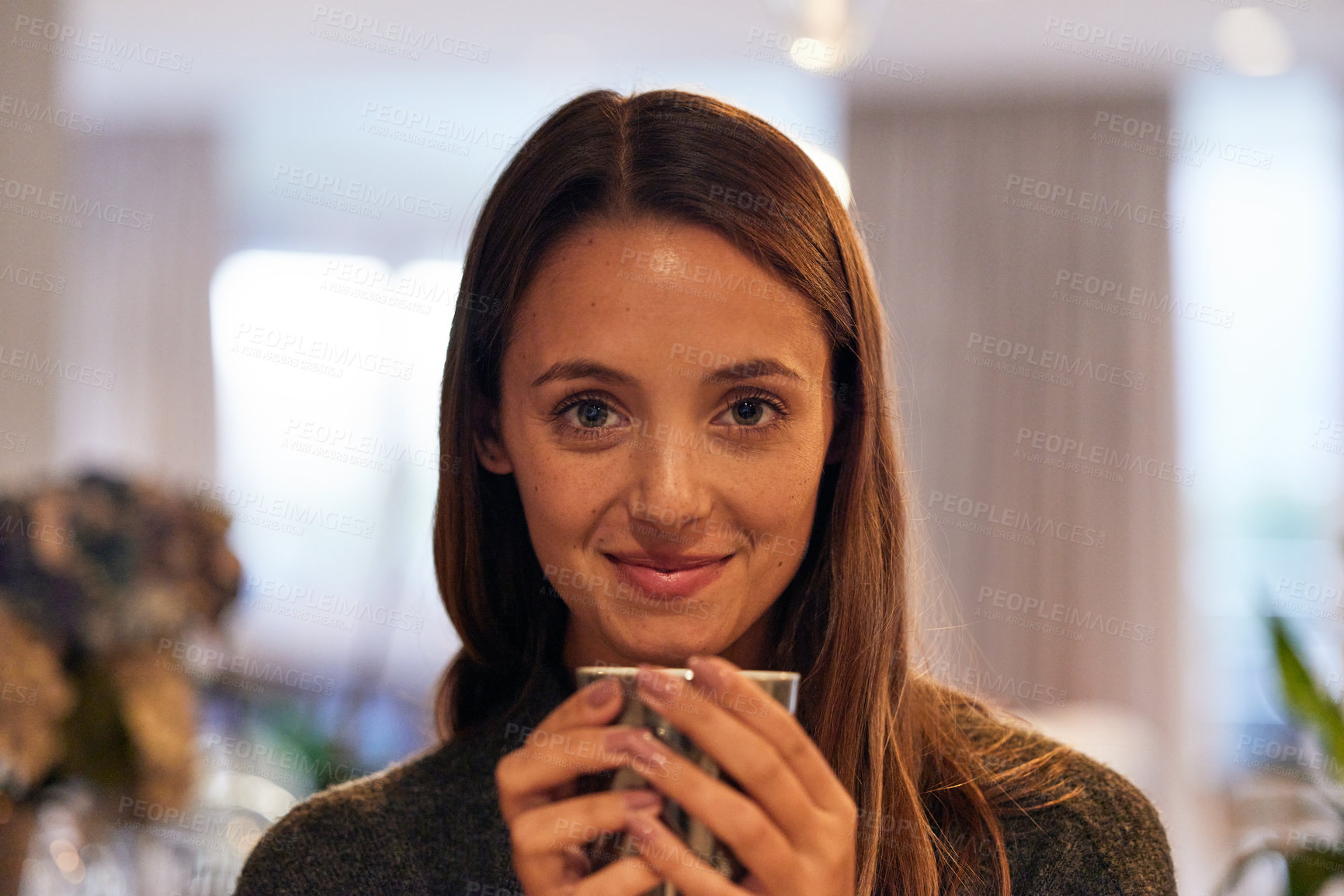 Buy stock photo Portrait of a young woman drinking a warm beverage at home