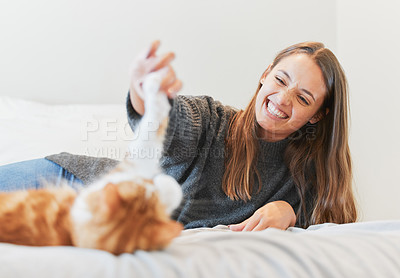 Buy stock photo Playing, smile and woman with cat in bedroom of home for bonding or love as pet owner. Bed, happy or toys and person having fun with adorable kitten in apartment for morning or winter relaxation