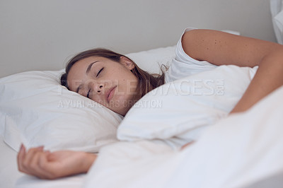 Buy stock photo Shot of a young female sleeping in bed at home