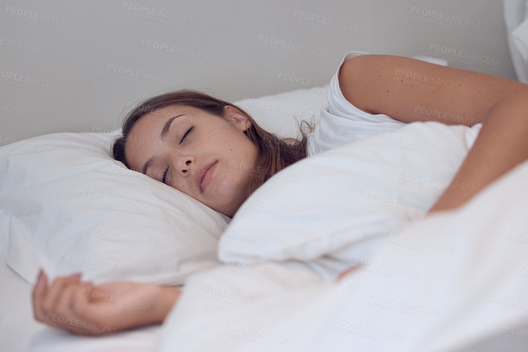 Buy stock photo Shot of a young female sleeping in bed at home