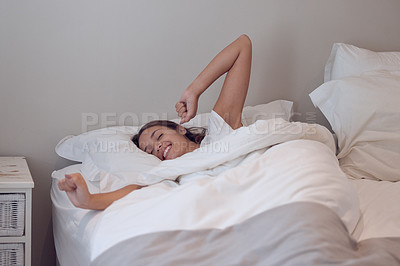 Buy stock photo Shot of a young female waking up in bed at home