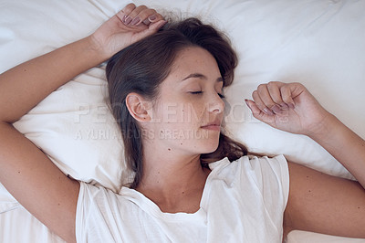 Buy stock photo Shot of a young female sleeping in bed at home