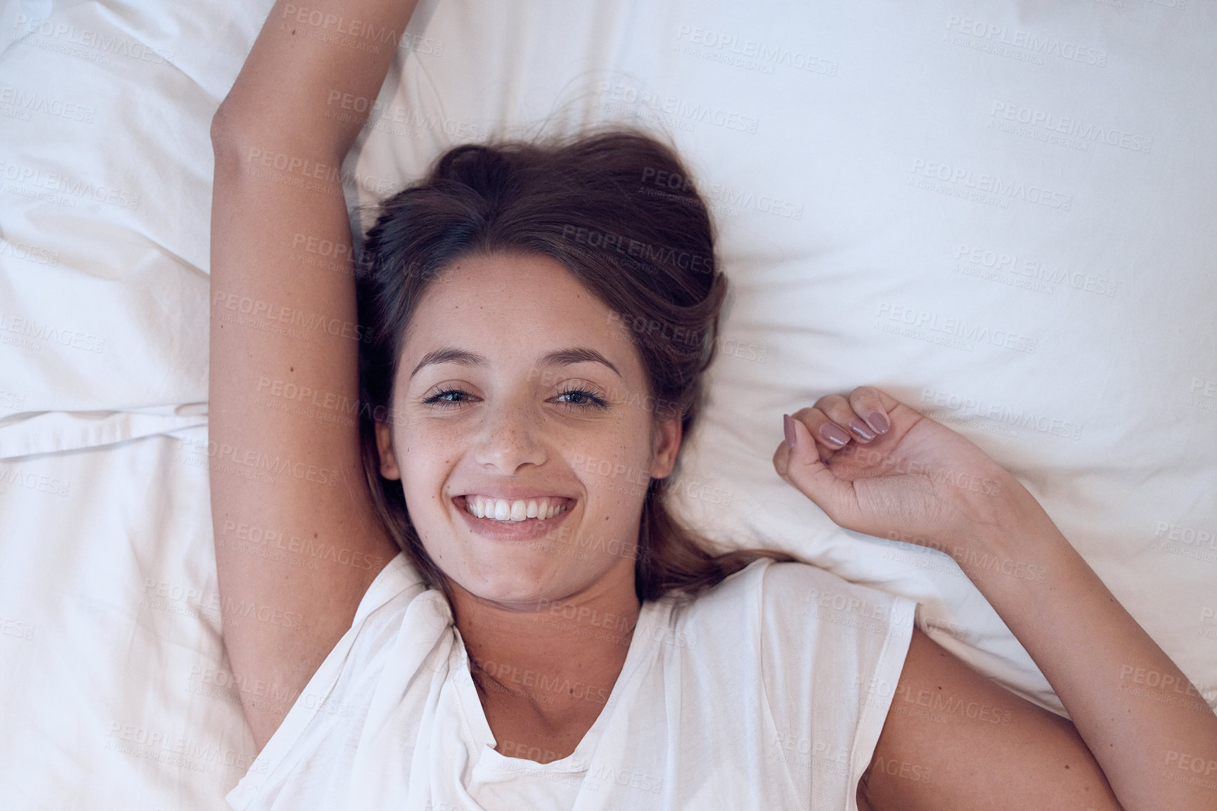 Buy stock photo Shot of a young female waking up in bed at home