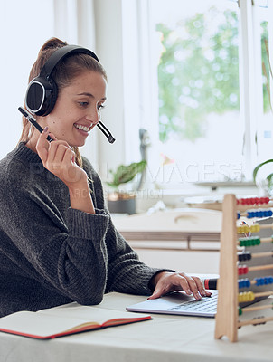 Buy stock photo Shot of a young teaching an online lesson with her laptop at home