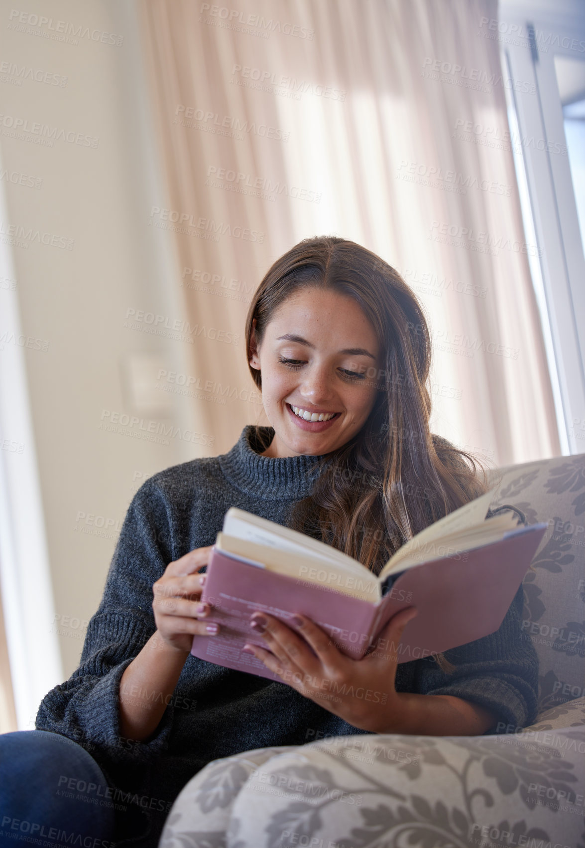 Buy stock photo Happy, young woman and reading book on sofa for story, novel or learning knowledge at home. Relax, female person and student with books for studying, literature and hobby in lounge or living room 