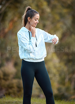 Buy stock photo Fitness, watch and heart rate with a woman runner outdoor checking pulse during a cardio or endurance workout. Exercise, health and bpm with a young female athlete looking at the time while running