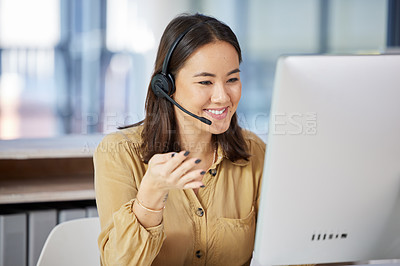 Buy stock photo Shot of a young businesswoman using a computer while working in a call centre