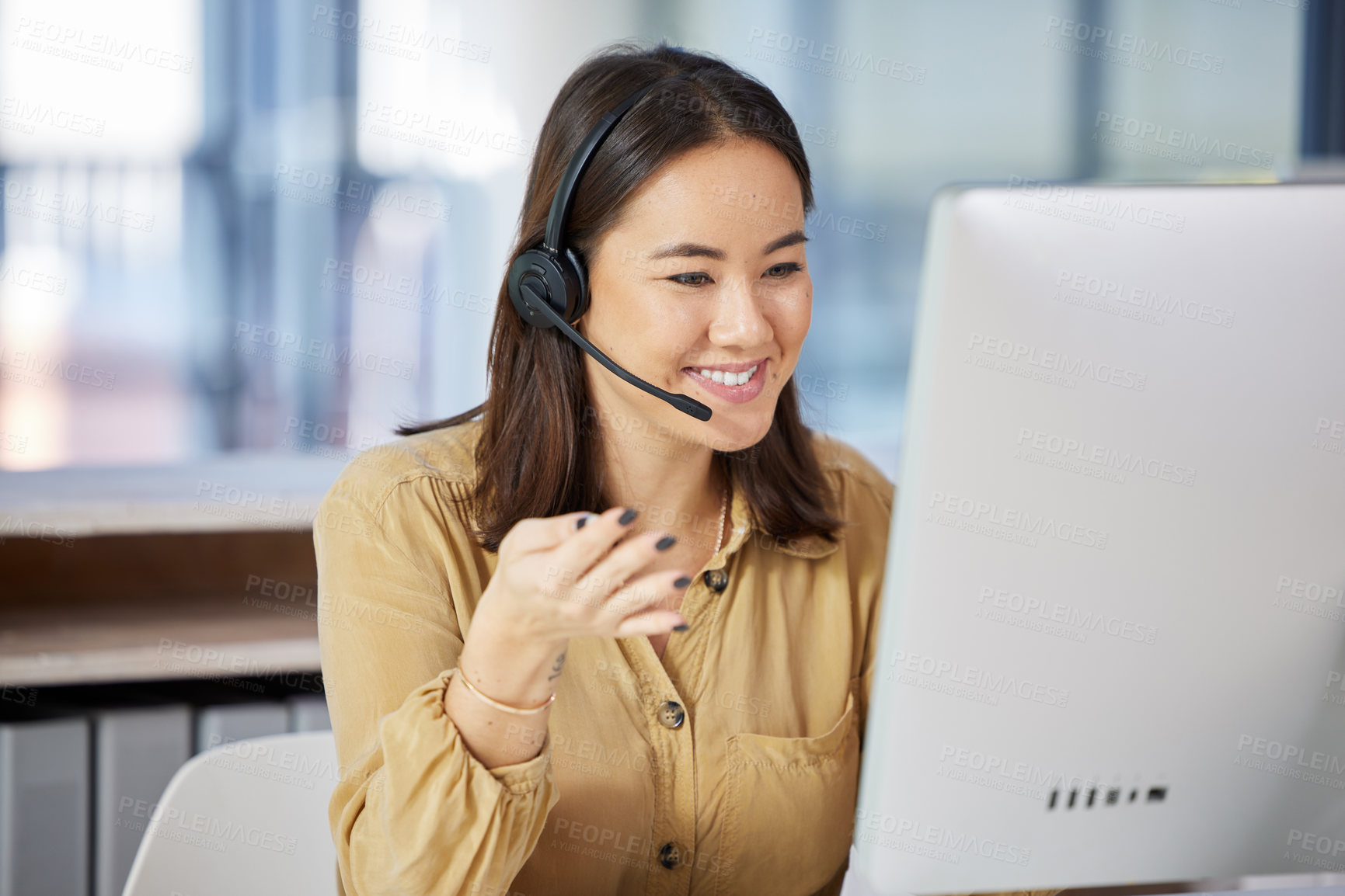 Buy stock photo Shot of a young businesswoman using a computer while working in a call centre