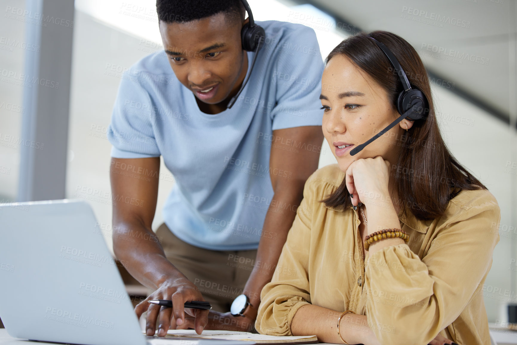 Buy stock photo Call center, customer service and manager helping a consultant with crm communication in the office. Contact us, headset and telemarketing agents working on online consultation together in workplace.