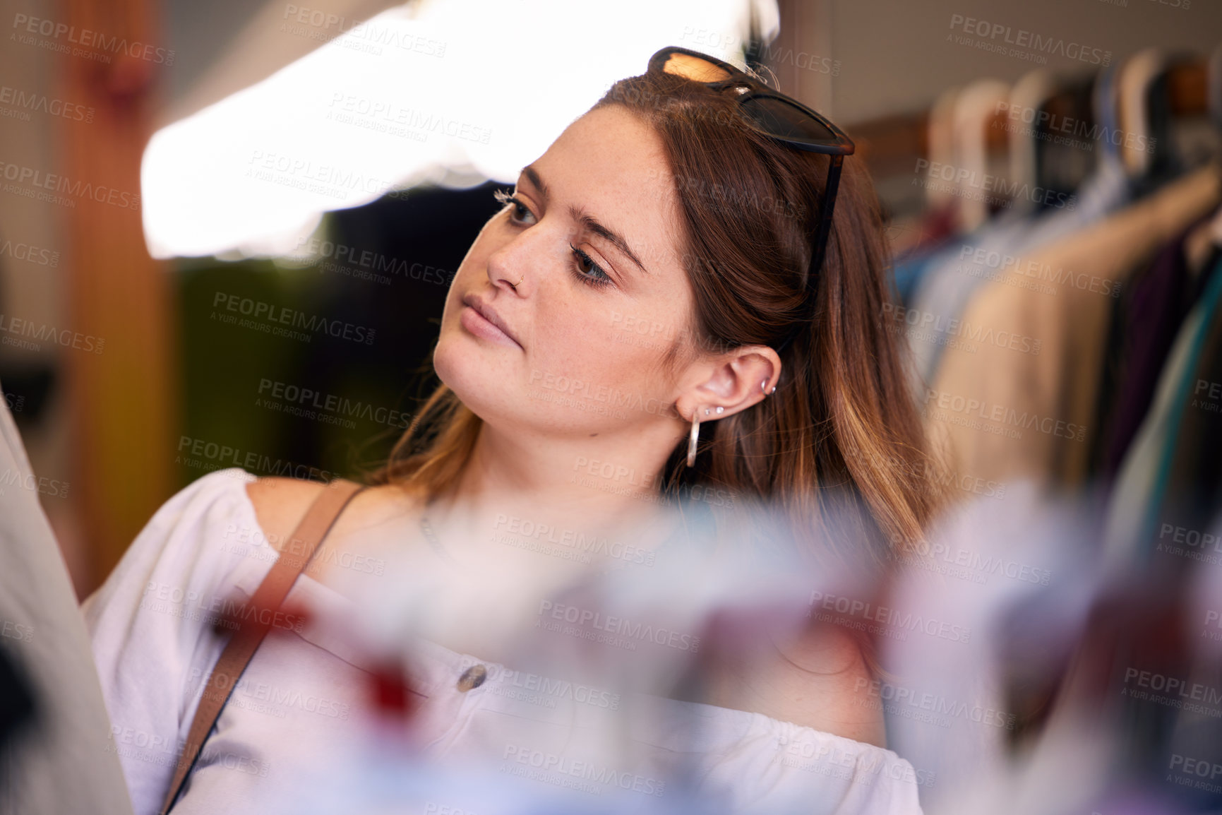 Buy stock photo Retail, woman and shopping clothes in boutique for fashion sale, choice and apparel for capsule wardrobe. Girl, browsing and buying outfit for spoils on holiday in Milan, selection and choosing.