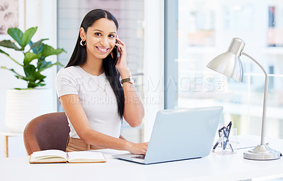 Buy stock photo Shot of a young businesswoman using her smartphone at work