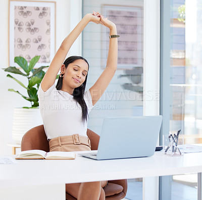Buy stock photo Shot of a young businesswoman taking a stretch break at work