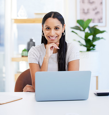 Buy stock photo Shot of a young businesswoman using her laptop at work