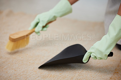 Buy stock photo Cropped shot of an unrecognizable using a hand broom and dustpan to clean her carpet at home