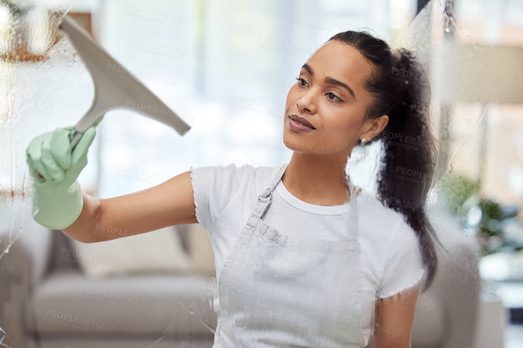 Buy stock photo Woman, housekeeping and cleaning with window wiper for bacteria or germ removal at home. Female person, maid or cleaner wiping or washing glass with gloves for hygiene, chores or cleanliness at house