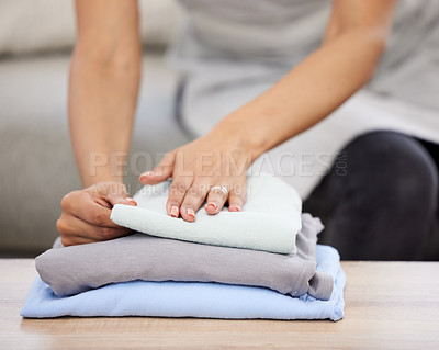 Buy stock photo Woman, hands and laundry with stack on sofa for clean clothing, chores or housekeeping at home. Closeup of female person, cleaner or maid with dry washing to pile for neat and tidy apartment or house