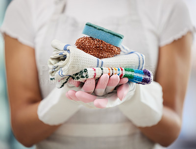 Buy stock photo Cropped shot of an unrecognizable woman standing alone at home and holding cleaning supplies
