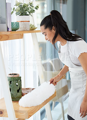 Buy stock photo Duster, girl and cleaning dust in home for housekeeping, furniture and maintenance with hygiene. Woman, happy and dusting shelf for housework with brush in house, living room and work in hospitality.