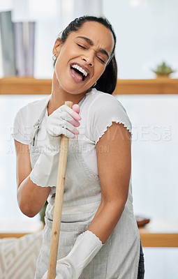 Buy stock photo Woman, cleaning with broom and singing in the home, energy and fun with music for housekeeping. Karaoke, kpop and concert in living room while sweeping, playful or crazy with house work or maid