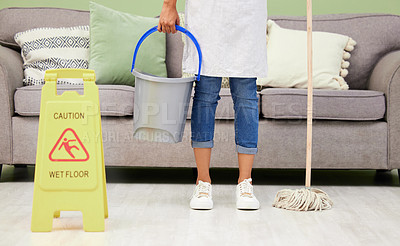 Buy stock photo Woman, cleaning and caution sign for wet floor, slippery and housekeeping maintenance for hygiene or disinfecting. Female maid, mopping and hospitality service in living room of home with warning.