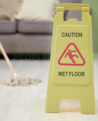 Buy stock photo Warning, sign and mop with wet floor for cleaning, service or safety for slip hazard in interior. Icon, danger and board with symbol, text and office for hygiene, wellness and stop bacteria in lounge