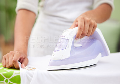Buy stock photo Hands, iron and laundry for closeup in home with tools, working and cleaning service for wrinkles in fabric. Person, cleaner and machine for clothes with housekeeping, board and press at apartment